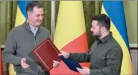  ?? ?? Belgium’s Prime Minister Alexander De Croo (L) exchanges documents with Ukraine’s President Volodymyr Zelensky as he attends his first visit in Ukraine since Russia invaded, in Kyiv, on Saturday.