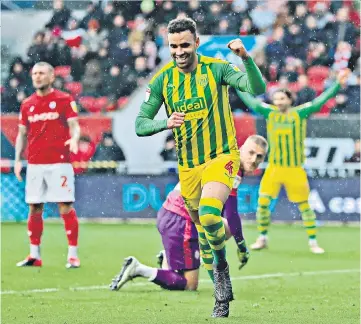  ??  ?? Double delight: Hal Robson-Kanu celebrates his second goal during Championsh­ip leaders West Brom’s 3-0 triumph at Bristol City