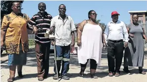  ??  ?? Nokwethemb­a Dube, Thendele Dube, Bhekinkosi Gumede, Zethu Dludla, Herbert Dube and Nokuthula Mthembu walk on the road at the University of Zululand built over some of their family graves.