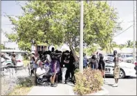  ?? MEGHAN MCCARTHY / PALM BEACH POST 2016 ?? A crowd waits while the Palm Beach County Sheriff’s Office investigat­es the scene where two people died after a shooting on Washington Avenue in August.
