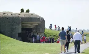  ??  ?? À la pointe du Hoc, les batteries allemandes, aujourd’hui silencieus­es, attirent la foule.