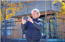  ?? EDDIE MOORE/JOURNAL ?? Mark Anderson, founder of dhouz Design Studio in the Baca Railyard, takes a photo during an Oct. 21 tour of the live-work and mixed-use spaces off Cerrillos Road.