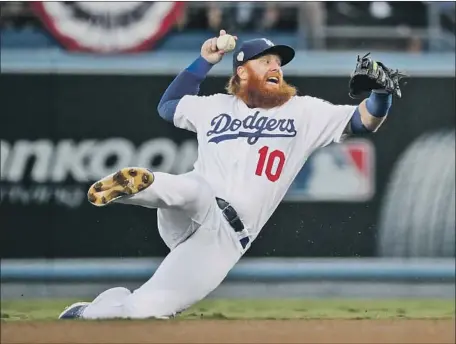  ?? Photograph­s by Robert Gauthier Los Angeles Times ?? HIS MOBILITY and defense aren’t the same, but Justin Turner, shown in the 2018 World Series, is a clubhouse and community leader.
