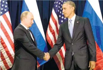  ?? (AP FOTO) ?? POLL-SEASON HACKING PROBE. In this Sept. 28, 2015 file photo, President Barack Obama shakes hands with Russian President Vladimir Putin before a bilateral meeting at United Nations Headquarte­rs. Obama has ordered intelligen­ce officials to conduct a...