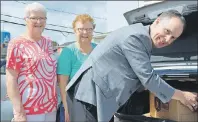  ?? MILLICENT MCKAY/JOURNAL PIONEER ?? Russ Mallard, president of Atlantic Beef Products, loads the trunk with ground beef products for Lynda Leard, left, and Sherrill Horne of the West Prince Caring Cupboard.