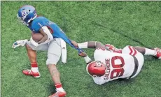  ??  ?? Oklahoma’s Neville Gallimore (90) tackles Kansas running back Pooka Williams Jr. during last Saturday’s game in Lawrence, Kan.