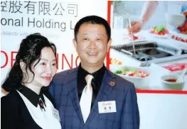  ?? — AFP ?? Zhang Yong, chairman and CEO of Sichuan Haidilao Catering, poses with his wife Shu Ping, before an investors’ luncheon ahead of the company’s IPO in Hong Kong.