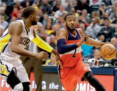  ?? AFP ?? John Wall (2) of the Washington Wizards dribbles against the Indiana Pacers. —