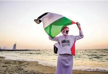  ??  ?? Raise the flag
At Jumeirah beach in Dubai Gulf News reader Aisha Mohammad Sultan took this picture to show Gulf News reader Manu Raghurajan took this picture at Ittihad Park in Palm Jumeirah and the pride the UAE’s citizens have for their country....