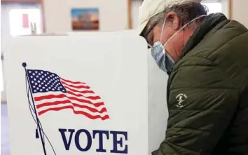  ?? — Reuters ?? A voter fills out his ballot at a polling station during the primary election in Peru, Illinois, on Tuesday.