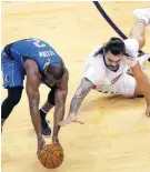  ?? [PHOTO BY SARAH PHIPPS, THE OKLAHOMAN] ?? Mavericks guard Raymond Felton and Thunder center Steven Adams battle for a loose ball during Monday night’s Game 2 in OKC.