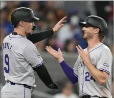  ?? FRANK GUNN — THE CANADIAN PRESS VIA AP ?? The Rockies’ Brenton Doyle, left, and Ryan Mcmahon celebrate after scoring on a hit by Kris Bryant during the fourth inning against the Blue Jays in Toronto on Friday.