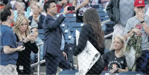  ?? AP ?? Una empleada del estadio se lleva el cartel de un aficionado antes del juego de pretempora­da entre los Astros de Houston y los Nacionales de Washington el sábado.