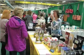  ?? LAUREN HALLIGAN — MEDIANEWS GROUP FILE ?? A vendor interacts with an attendee at the 10th annual New York Women’s Expo at Siena College.