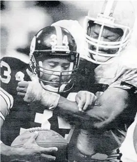  ?? ASSOCIATED PRESS ?? Carl Hairston, wrapping up Steelers running back Walter Abercrombi­e, played 15 seasons in the NFL for the Browns, Eagles and Cardinals, registerin­g an unofficial 94 sacks.