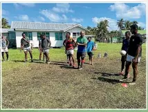  ?? ?? Seremaia Bai passing on his rugby knowledge to kids in Fiji.