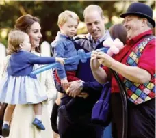  ?? CHRIS WATTIE/REUTERS ?? The Duke and Duchess of Cambridge and their children, Princess Charlotte and Prince George, at a party for military families in Victoria, B.C.