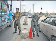  ?? AFP ?? Afghan policemen stand guard at a checkpoint along the road in Kabul on Saturday.