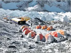  ??  ?? Challenge: Fogle and Pendleton must wait at Base Camp for better weather. Below, crossing ladders over crevasses