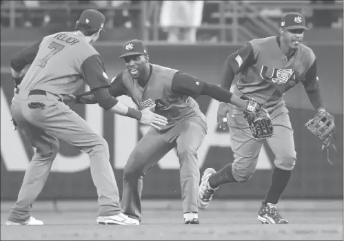  ??  ?? ( From left) Christian Yelich, Andrew McCutchen and Adam Jones of the US celebrate their 2- 1 semifinal win over Japan during the 2017 World Baseball Classic on Tuesday in Los Angeles.