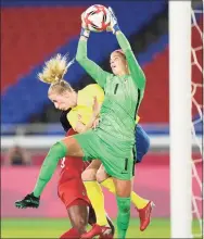  ?? Andre Penner / Associated Press ?? Sweden’s Sofia Jakobsson, left, and Canada’s goalkeeper Stephanie Labbe battle for the ball during the gold-medal match at the 2020 Summer Olympics on Friday.