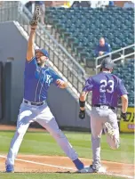  ?? JOHN SLEEZER/THE KANSAS CITY STAR VIA AP ?? Royals first baseman Eric Hosmer pulls down a high throw for an out on the Rockies’ Tom Murphy during spring training Thursday in Surprise, Ariz.