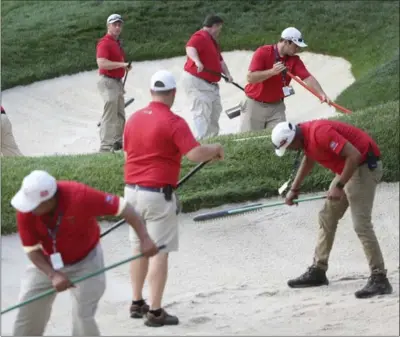  ?? SETH WENIG, THE ASSOCIATED PRESS ?? Members of the grounds crew groom a sand trap during a practice round for the PGA Championsh­ip golf tournament at Baltusrol Golf Club in Springfiel­d Township, N.J., on Monday.