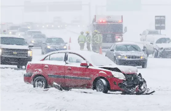  ?? GAVIN YOUNG ?? Emergency workers deal with a multi-car collision on Deerfoot Trail at Southland Drive Sunday. At least 10 cars were involved in several different accidents at the same location.