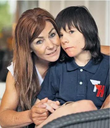  ??  ?? Charlotte Caldwell with her son Billy. She had cannabis oil, prescribed in Canada for his epilepsy, confiscate­d at Heathrow airport when she returned to Britain. The Home Secretary yesterday used an ‘exceptiona­l power’ to ensure that the 12-year-old...