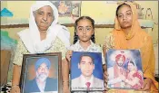  ?? BHARAT BHUSHAN/HT ?? (From left) Jaspal Kaur, her granddaugh­ter Amarpreet and daughterin­law Rajbir Kaur holding photograph­s of their family members in Fatehgarh Sahib.