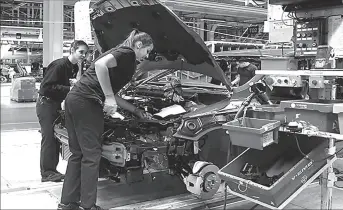  ?? BRUSSELS
-REUTERS ?? Workers assemble a car at AB Volvo's factory in Belgium.