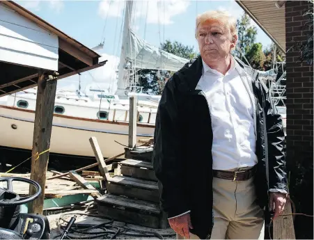  ?? EVAN VUCCI / THE ASSOCIATED PRESS ?? Donald Trump visits a neighbourh­ood impacted by Hurricane Florence in New Bern, N.C. The president said Wednesday that judge Brett Kavanaugh, accused of sexual assault, has an ‘unblemishe­d record.’