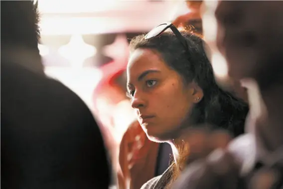  ?? Photos by Scott Strazzante / The Chronicle ?? A young woman listens to Alexandria Ocasio-Cortez speak. Many said they found the New York candidate to be more authentic than most politician­s.