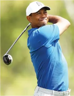  ?? — AFP photo ?? Tiger Woods plays his shot from the third tee in his match against Aaron Wise during the first round of the World Golf Championsh­ips-Dell Match Play at Austin Country Club in Austin, Texas.