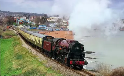  ??  ?? Newly-resident on the award-winning Dartmouth Steam Railway, Peter Best’s USATC S160 2-8-0 2253 Omaha climbs away from Goodringto­n with a train for Kingswear on February 18, at a classic location more familiarly associated with high summer. JOHN STORER