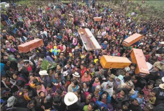  ?? Luis Soto / Associated Press ?? Residents carry the remains of relatives who were killed during the civil war, to finally be buried in the hamlet of Santa Avelina. Many died from malnutriti­on and treatable illnesses.