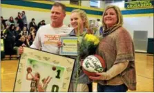  ?? BOB RAINES — DIGITAL FIRST MEDIA ?? Lauren Crim is honored for making her 1000th point, Saturday, at Lansdale Catholic High School. With her are her parents, Scott and Christine Crim,