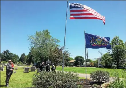  ?? EVAN BRANDT — DIGITAL FIRST MEDIA ?? Montgomery County Sheriff’s Deputies, from left, Adam Seanor, Mike Wambold and Kasey Sapp salute after raising the U.S. and Pennsylvan­ia flags during a Flag Day ceremony Thursday at Edgewood Cemetery in Pottstown. At left is cemetery overseer Andrew Monastra.