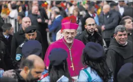  ?? Majdi Mohammed The Associated Press ?? Latin Patriarch of Jerusalem Pierbattis­ta Pizzaballa arrives on Christmas Eve at the Church of the Nativity, built atop the site where Christians believe Jesus Christ was born, in the West Bank City of Bethlehem.