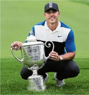  ?? — AP ?? All smiles: Brooks Koepka posing with the Wanamaker Trophy after winning the PGA Championsh­ip at Bethpage Black in Farmingdal­e on Sunday.