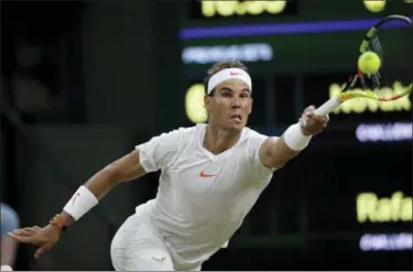  ?? BEN CURTIS — ASSOCIATED PRESS ?? Rafael Nadal returns a ball to Novak Djokovic during their semifinal match at Wimbledon in London.