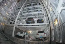  ?? YANG DONG / FOR CHINA DAILY ?? A nine-story parking tower is put into operation in Xiangyang, Hubei province, on Sunday. The first in the city, the self-service facility is able to host 99 cars and will ease the shortage of parking spaces in the city center.