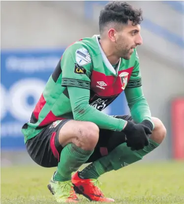  ??  ?? Feeling low: Navid Nasseri reacts after seeing his penalty saved by Glenavon’s Jonny Tuffey