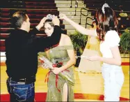  ?? PHOTO COURTESY OF LIFETOUCH NATIONAL STUDIOS ?? Lincoln senior Nadia Ortiz is crowned 2021 Colors
Day queen by her father, Julian Ortiz, with 2020 queen Abby Goldman assisting during ceremonies held at Wolfpack Arena on Friday.