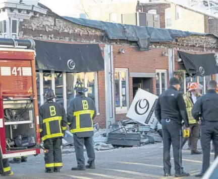  ?? NICOLAUS CZARNECKI/ BOSTON HERALD ?? DANGER: A Boston Fire Department crew investigat­es the scene of a partial building collapse yesterday on Harvard Avenue in Allston in front of the Common Ground Bar and Grill.