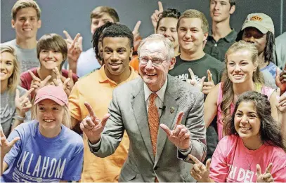  ?? [PHOTO PROVIDED BY OSU] ?? President Burns Hargis and freshman students fire their “pistols” as the 2015 fall semester begins at Oklahoma State University.