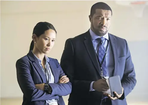  ?? — BEN MARK HOLZBERG ?? Alli Chung and Roger Cross star as detectives in CBC’s Coroner, a new series launching Monday.