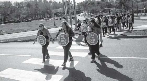  ?? TIM KROCHAK ■ THE CHRONICLE HERALD ?? Teachers from the Nova Scotia Teachers Union hold a picket rally during the afternoon commute, on the Armdale Rotary in Halifax Monday. The NTSU members recently voted 98 per cent of a strike mandate.