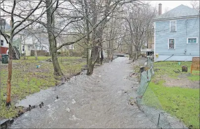  ?? GREG MCNEIL/CAPE BRETON POST ?? An overflowin­g stream is seen from Union Street in the north end of Sydney. The stream flows between Union and Park streets in the community.