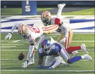  ?? ADAM HUNGER — THE ASSOCIATED PRESS ?? San Francisco 49ers cornerback Dontae Johnson (27) strips the ball fromNew York Giants wide receiver Darius Slayton (86) on Sunday in East Rutherford, N.J.